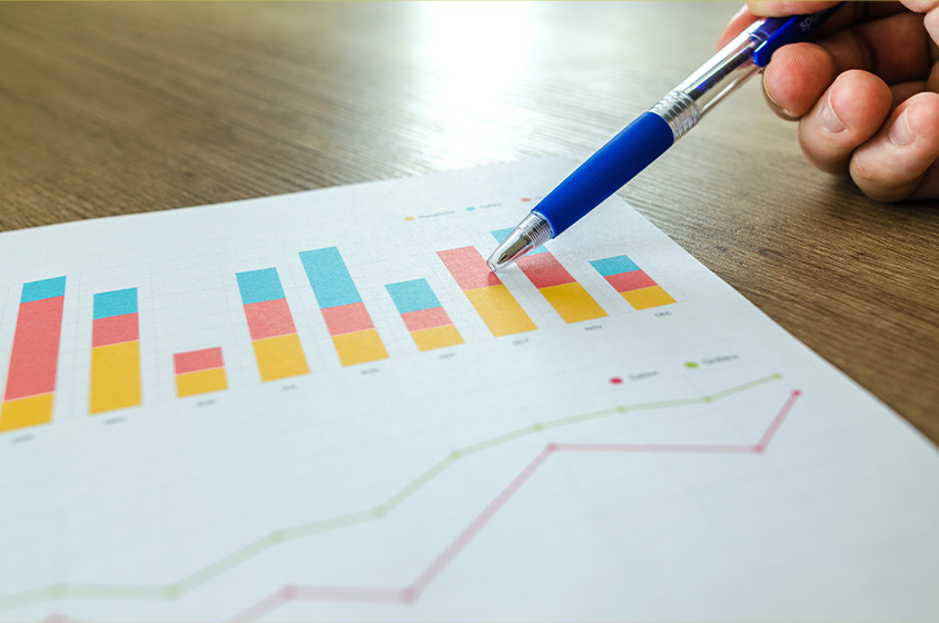 pen pointing at printed chart